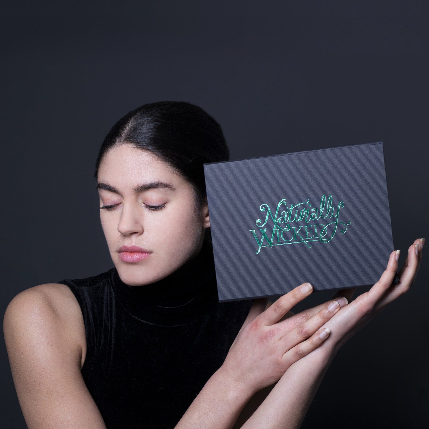 Naturally Wicked Personalised Deluxe Kit In Hands Of Wicked Woman With Beautiful Skin